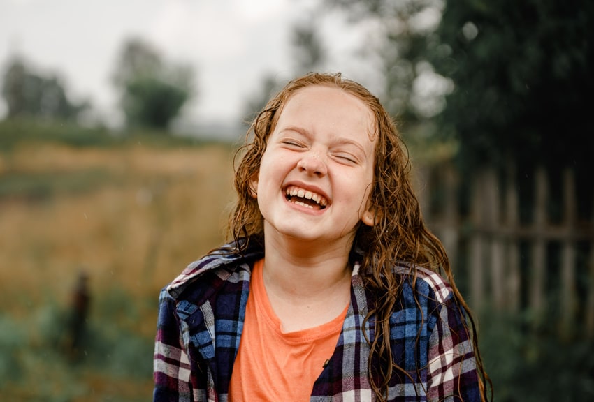 smiling girl in the rain after hypnotherapy