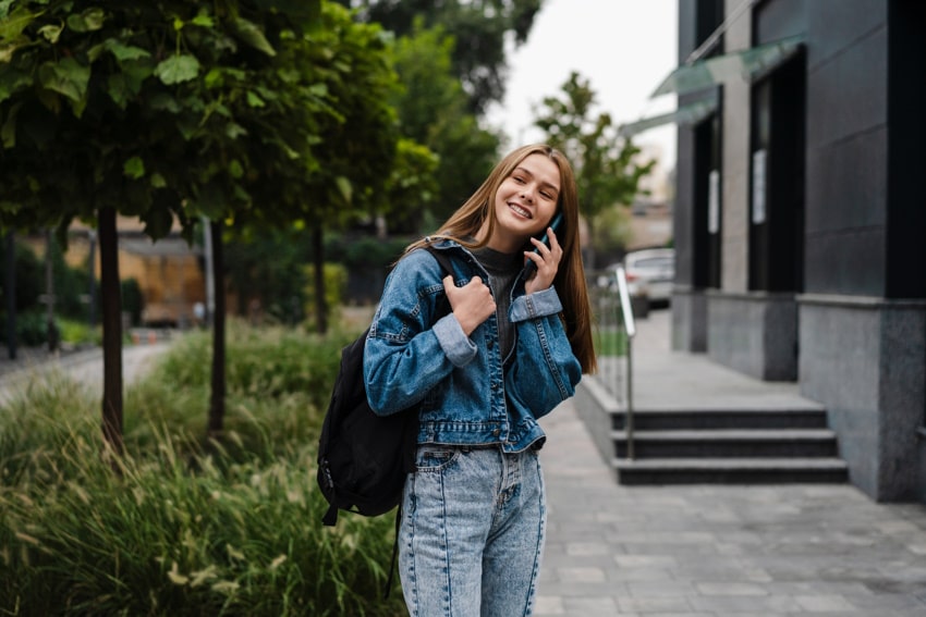 Teen girl on the phone, smiling after hypnotherapy